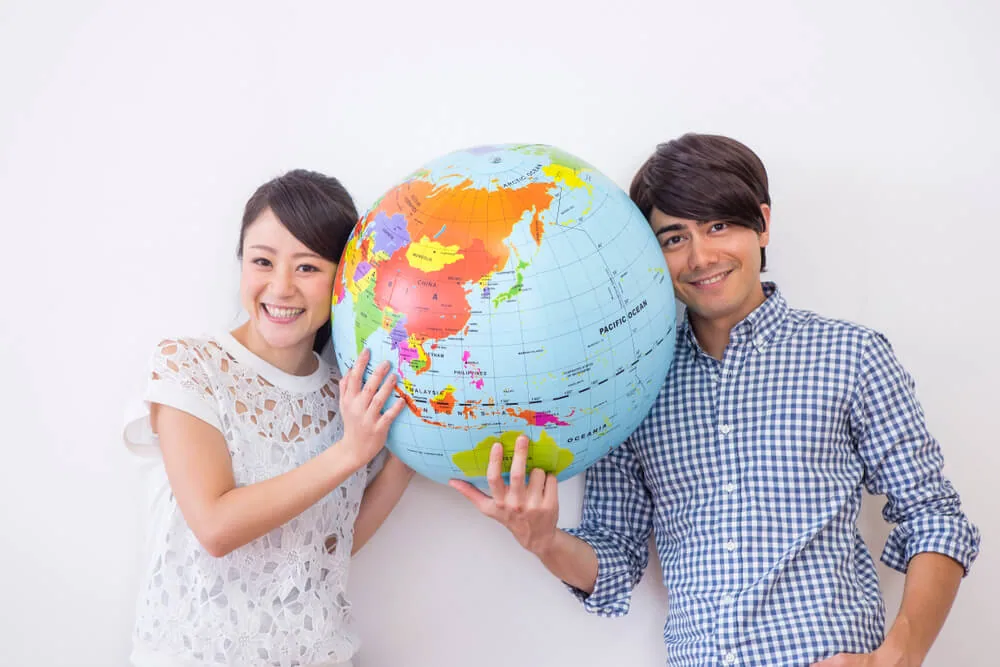 地球儀を持って楽しそうな男性と女性