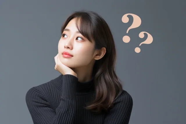 女性が考えている様子とクエッションマーク