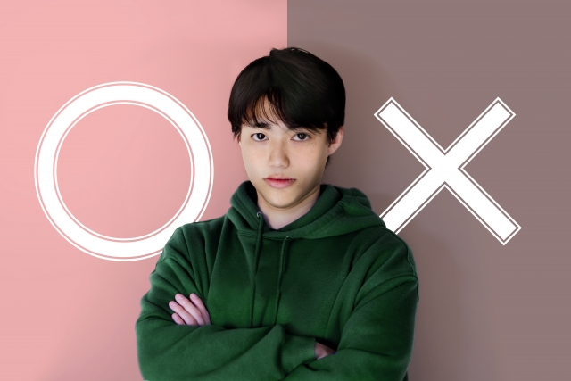 〇と×の前にいる男性